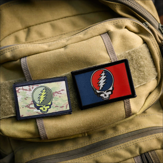 Steal Your Face Morale Patch on a tan backpack