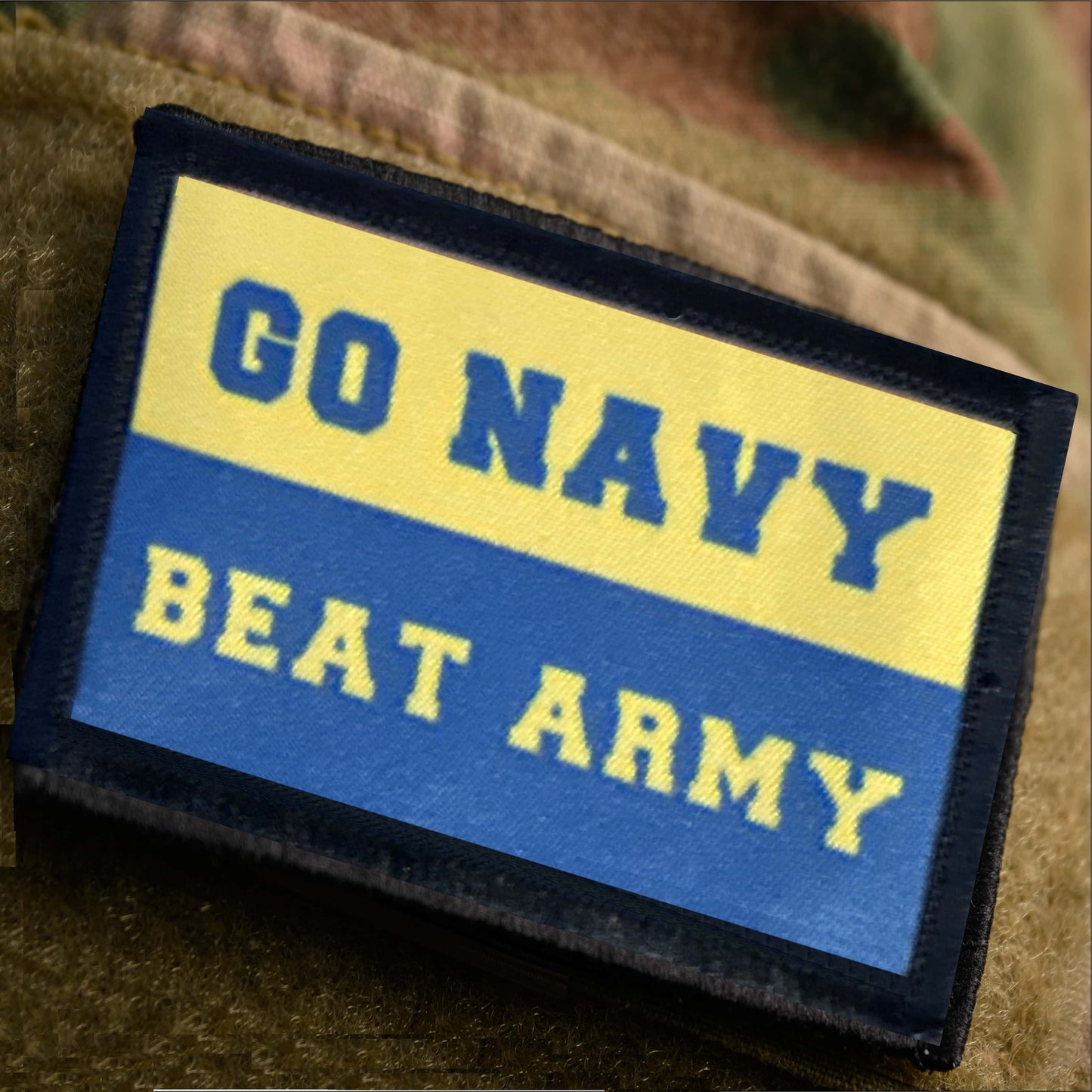 GO NAVY BEAT ARMY hook and loop morale patch on multicam jacket sleeve