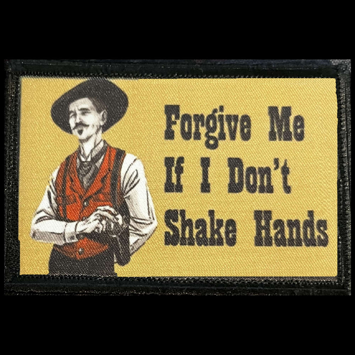 Main image of the Forgive Me If I Don't Shake Hands morale patch with a mustached Western gunslinger, black hat, red vest, and gold background