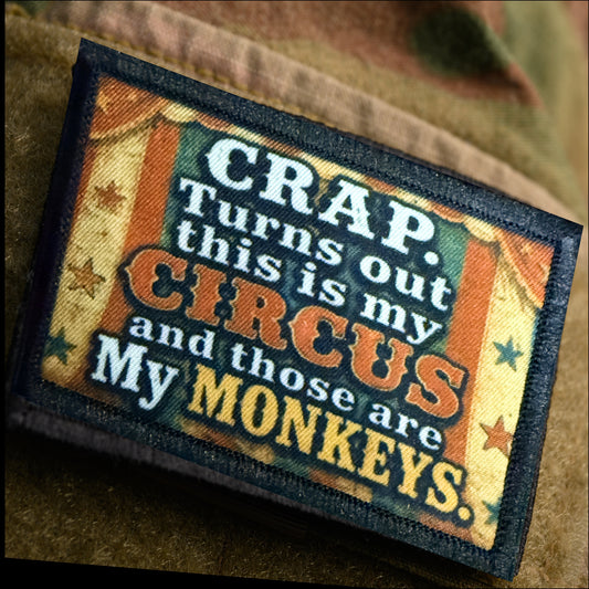 Not My Circus My Monkeys patch affixed to an OCP camo sleeve, showing how the vintage circus-poster colors pop against multicam patterned fabric.