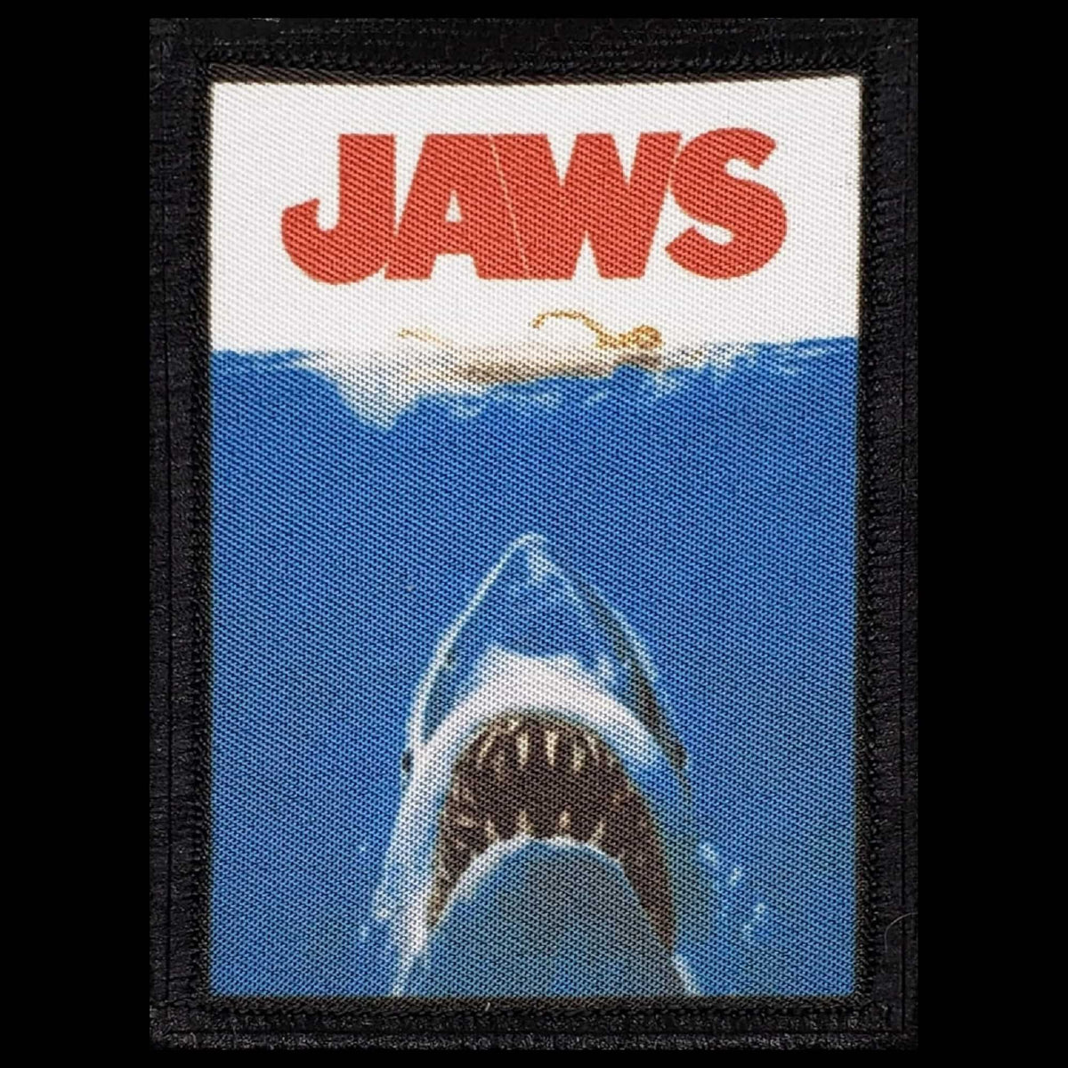 Jaws Shark Morale Patch showing the classic movie poster great white shark rising from deep blue water with bold red JAWS title text