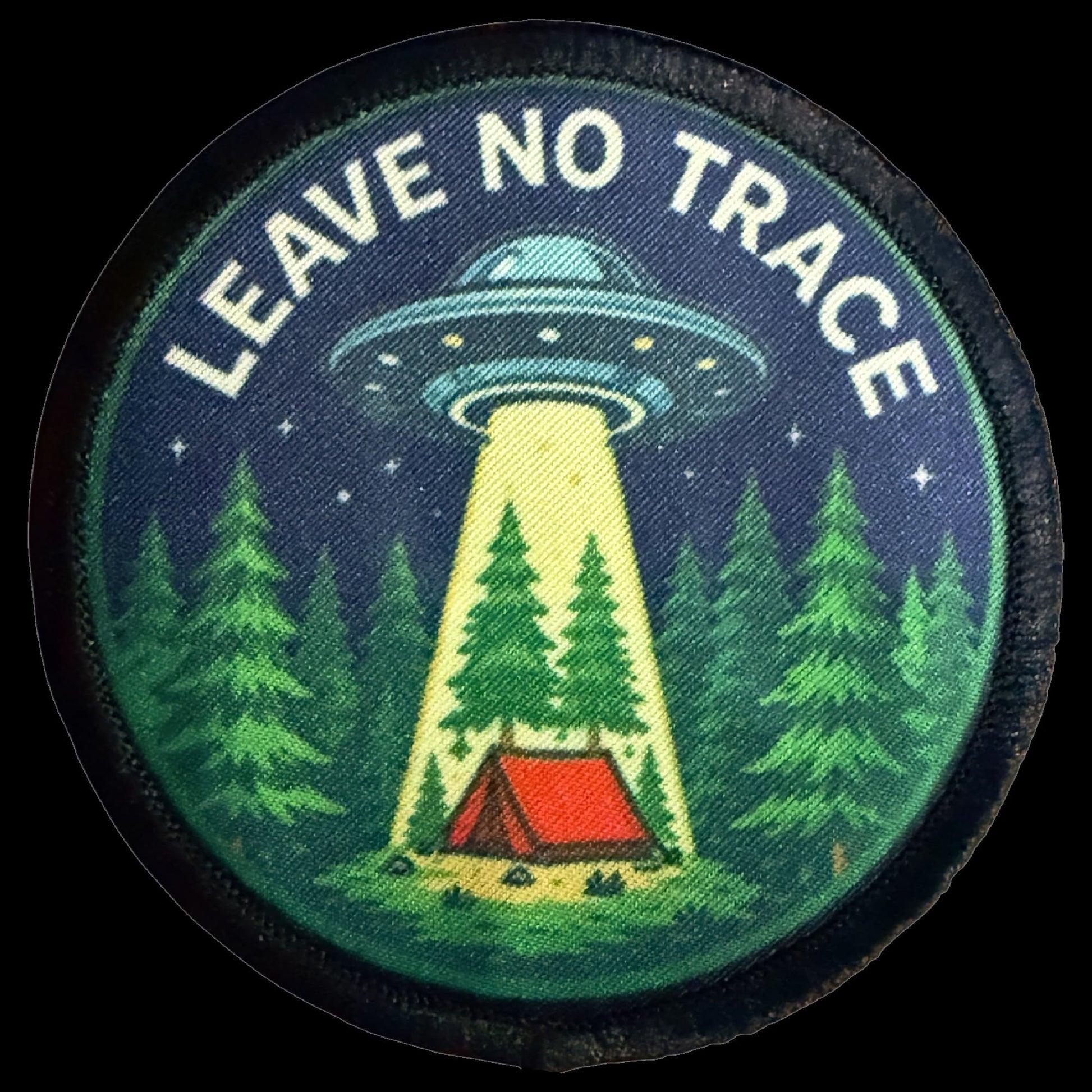 Leave No Trace UFO Morale Patch showing a flying saucer beaming up a red camping tent in a pine forest under a starlit sky.
