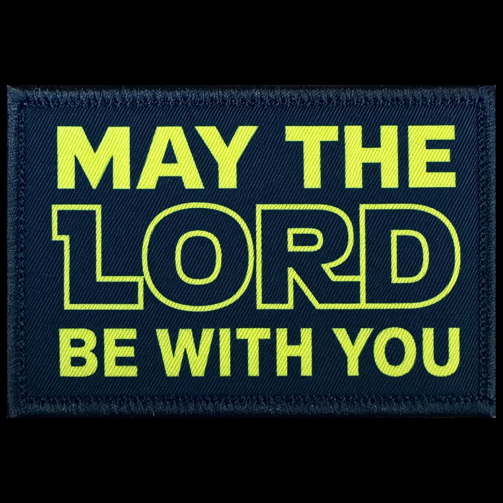 May The Lord Be With You morale patch with Yellow Star Wars styled lettering on a black background, 2x3 inch hook-and-loop fabric patch