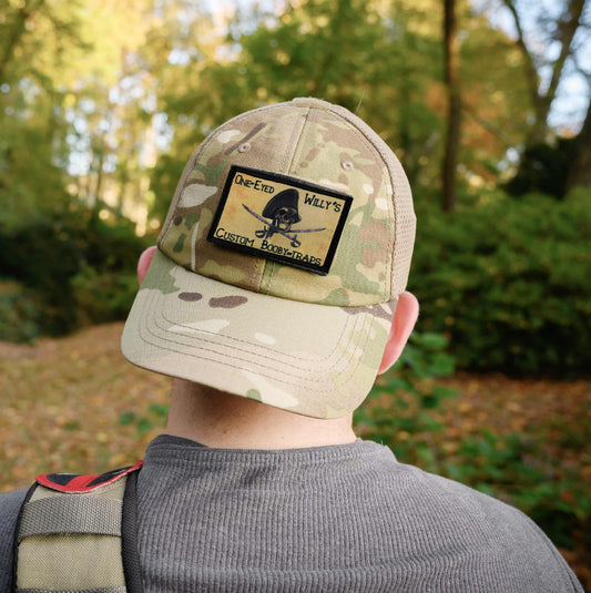 Goonies One Eyed Willy's Custom Booby Traps Morale patch on an OCP camo tactical cap