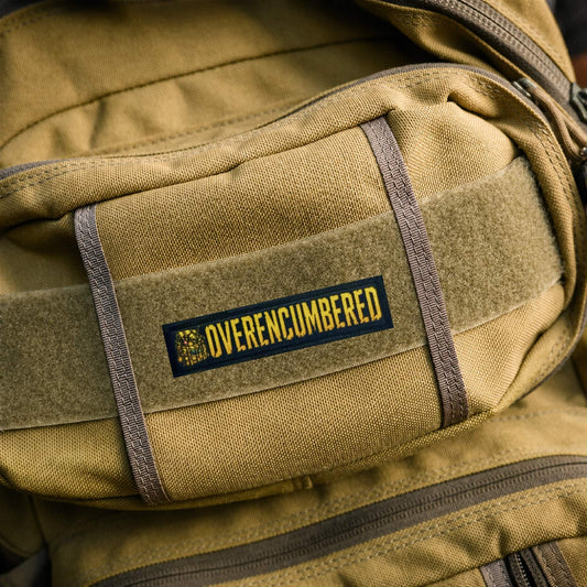 Overencumbered morale patch with hook and loop backing for attaching to plate carriers and range bags