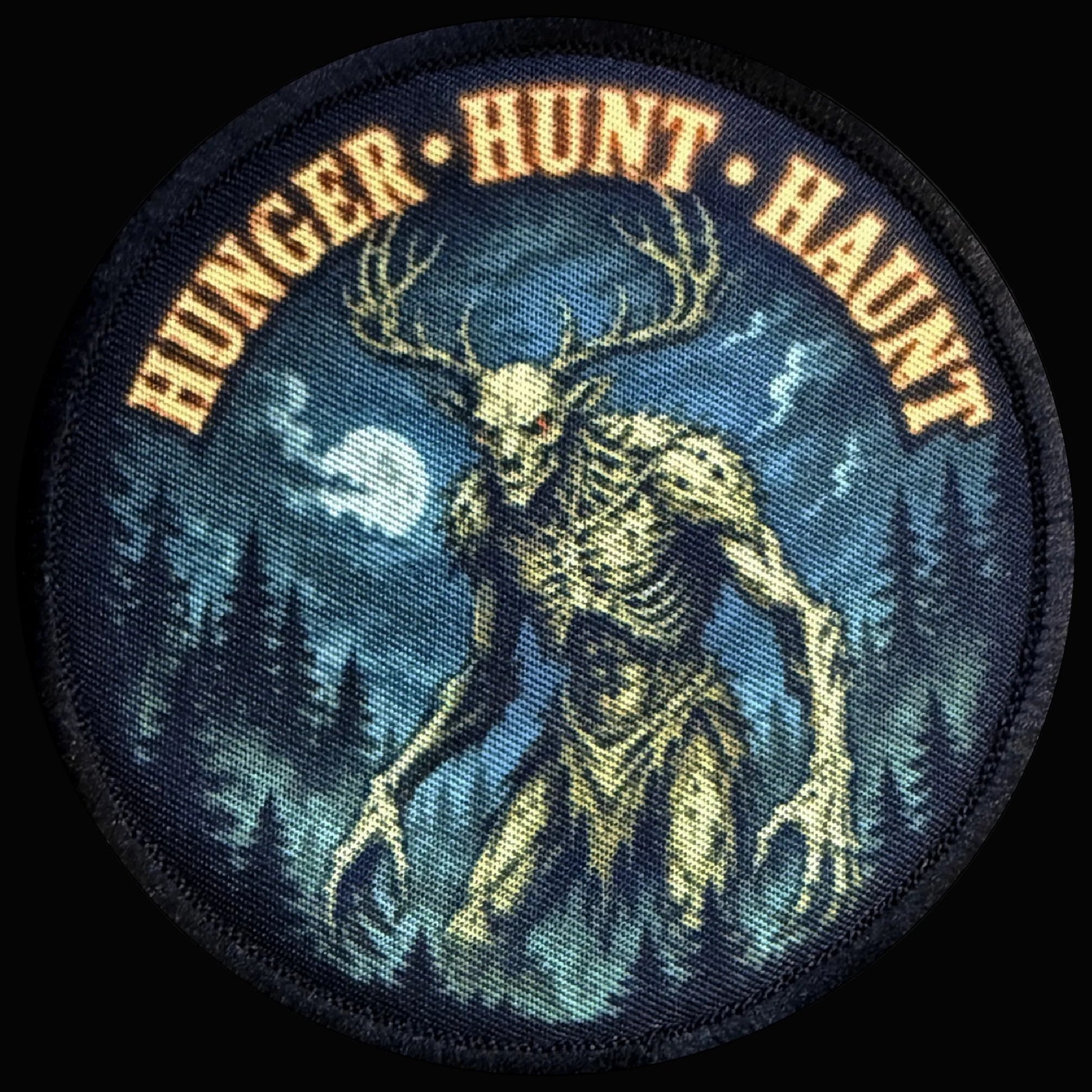 Wendigo Morale Patch showing a skeletal antlered cryptid stalking through a moonlit pine forest with glowing red eyes