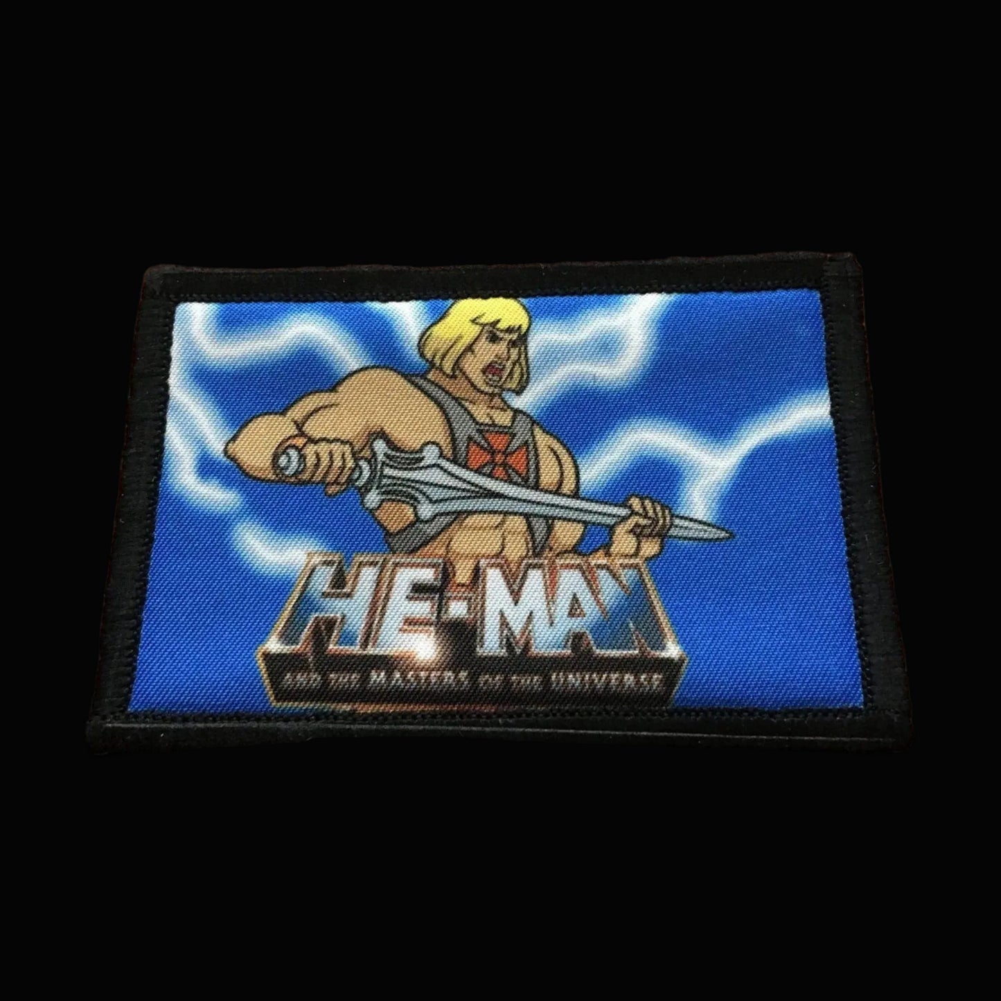 Morale Patch featuring He-Man from Masters of the Universe on a blue background with lightning.