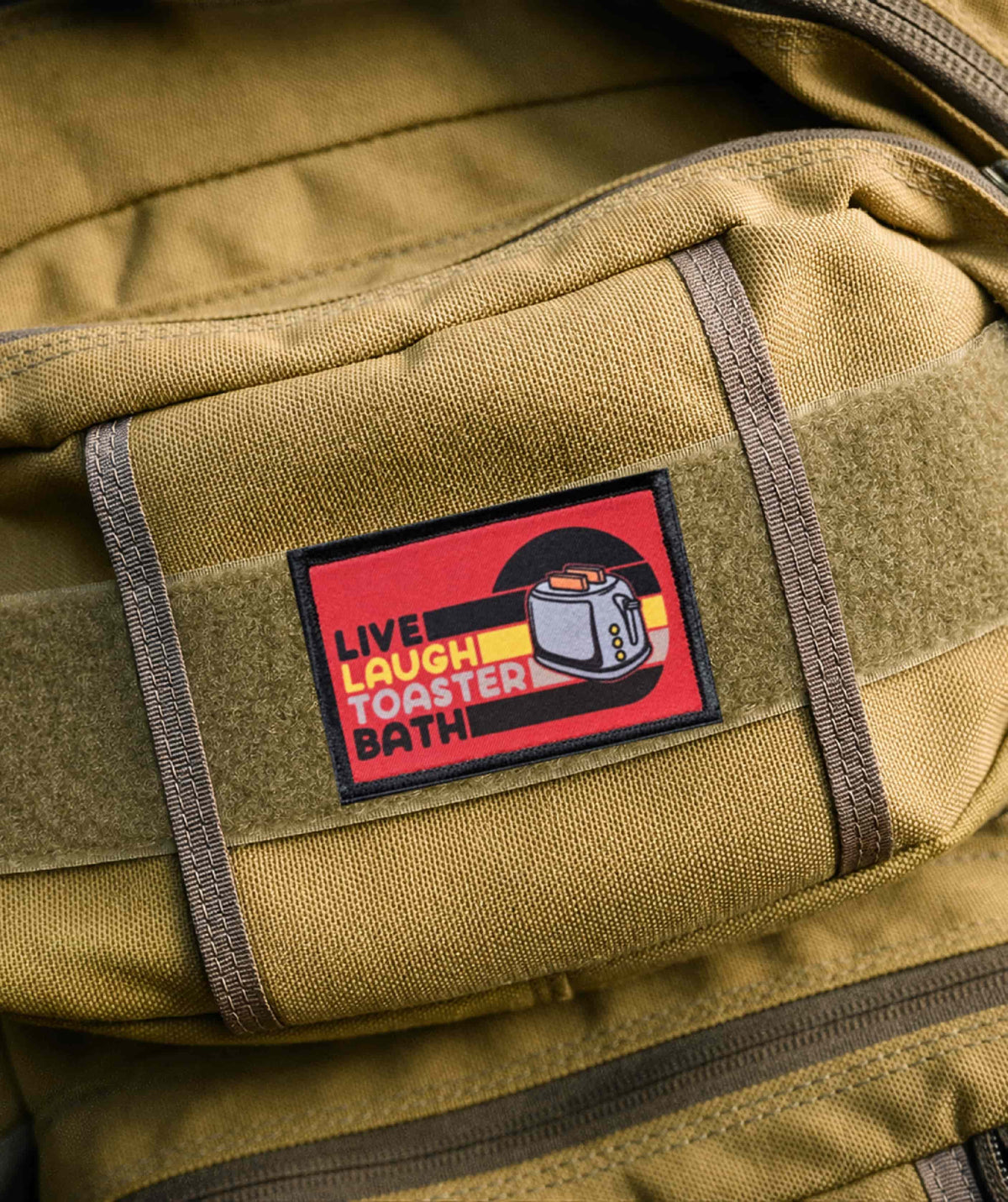  Live Laugh Toaster Bath morale patch attached to the loop panel of a tactical vest